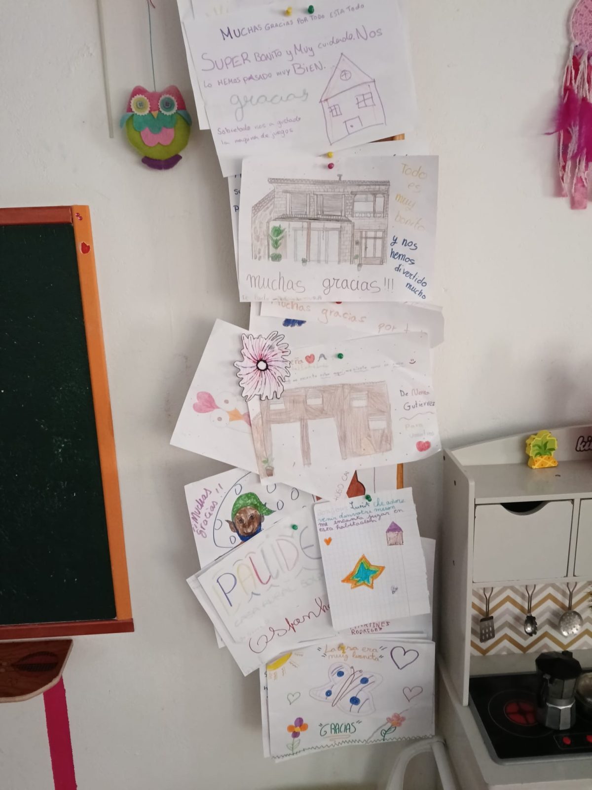 Dessins et mots des hôtes exposés près du tableau de la salle de jeux de Solapeña